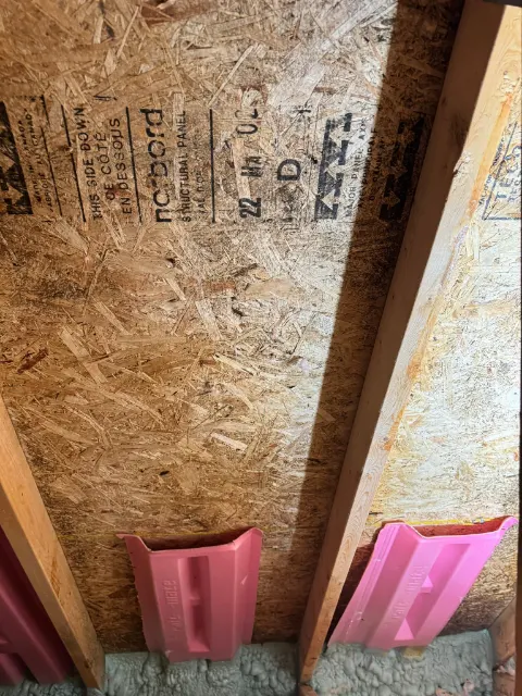 Attic sheathing and insulation baffles at the roof edge