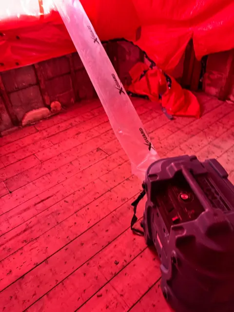 Containment tent with a negative air duct over a subfloor