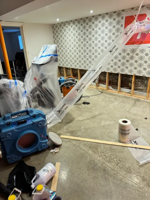 Containment, a dehumidifier and negative air ducting in a room with flood-cut walls