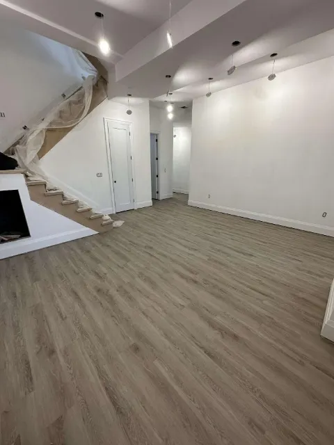Finished basement with new flooring and pot lights