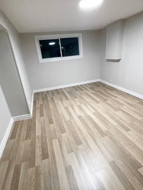 Finished basement room with new flooring