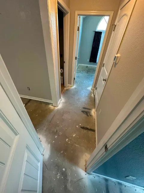 Hallway stripped to the subfloor during repairs