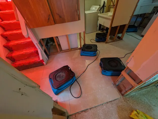 Air movers drying a laundry room with the walls opened