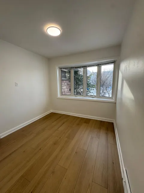 Bedroom with new plank flooring and fresh paint