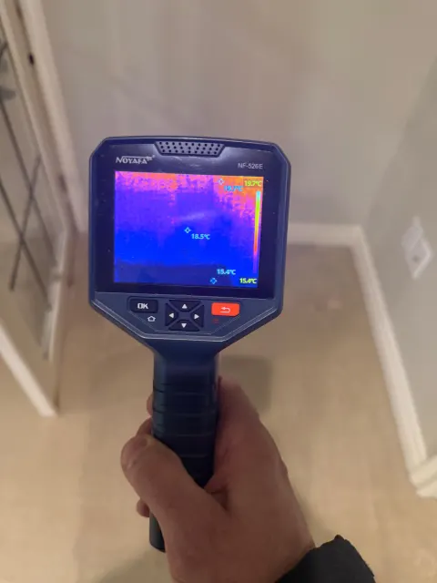 Thermal camera reading moisture in a wall corner